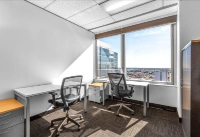 Private two-person office suite featuring large windows and city views.