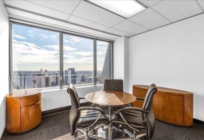 Professional four-person meeting room with wooden sideboards and natural light.