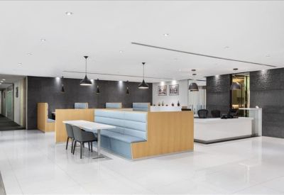 Bright reception area and lounge with light blue booth seating.