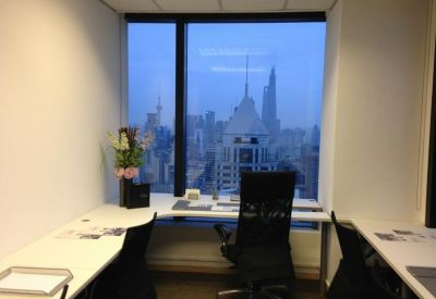 Private office workspace with city views and floral arrangement.