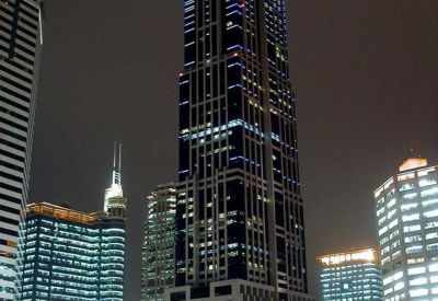 Portrait night view of the illuminated skyscraper at HK New World Tower.
