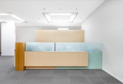 Minimalist light wood reception desk with frosted glass accents.
