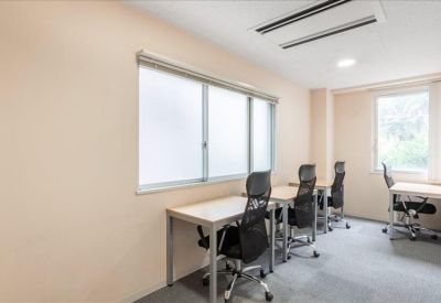 Private office suite with three black mesh chairs and light wood desks.