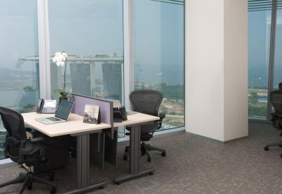 Private window office with dual workstations, ergonomic chairs, and panoramic city views.