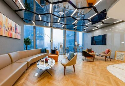Lounge area with modern furnishings and wooden flooring.
