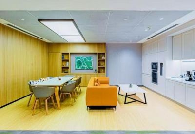 Meeting room with a large table and six chairs, adjacent to a kitchenette.