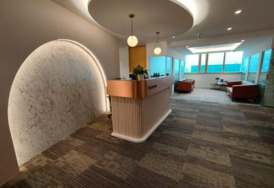 Modern reception desk with a copper trim and an arched marble feature wall.