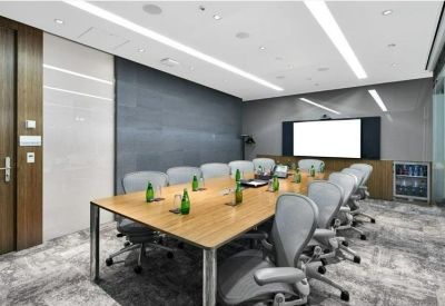 Spacious boardroom with a large wooden table and ergonomic grey chairs.