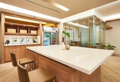 Spacious communal kitchen area with a large wooden island and modern appliances.