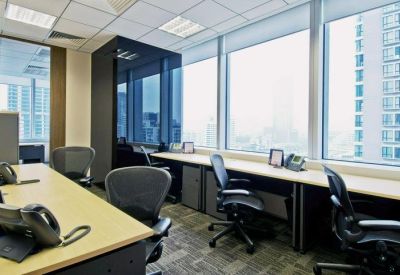 Open-plan office space with dedicated workstations and large windows overlooking the city.