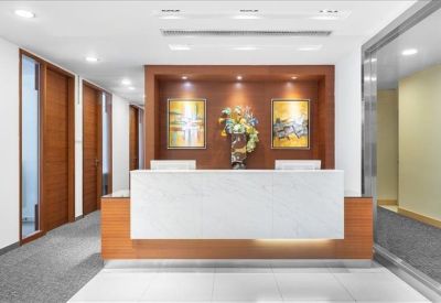 Bright reception area featuring a white marble desk against a warm wood-paneled feature wall.