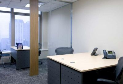 Professional two-person office suite with light wood desks and ergonomic chairs.