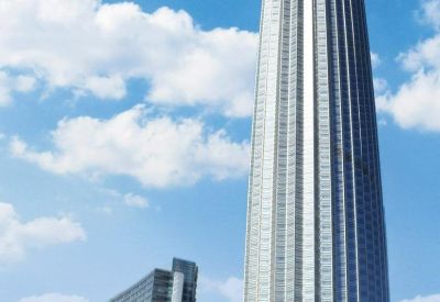 Exterior view of the soaring glass-facade Tianjin World Financial Centre against a bright blue sky.