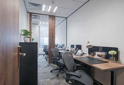 Private office suite with two workstations and a glass partition wall.
