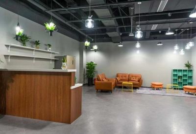 Welcoming reception area with a wooden front desk and orange leather seating.