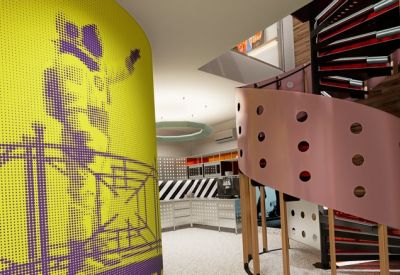 Entryway view showing a yellow pillar with purple graphics and a unique copper spiral staircase.