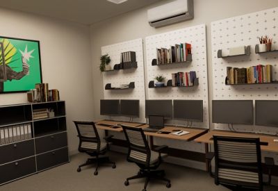 Three-person office with pegboard wall storage and triple monitor setup.