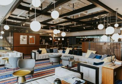 Large breakout lounge with sphere pendant lights and plush seating.