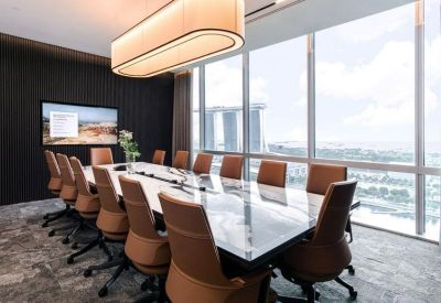 Sunlit boardroom with a marble table, leather chairs, and views of the Singapore skyline.