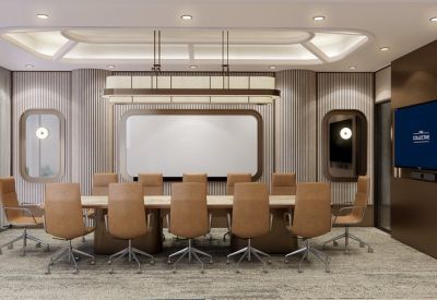 Spacious boardroom with a large rectangular table, tan leather chairs, and a sleek recessed ceiling light.