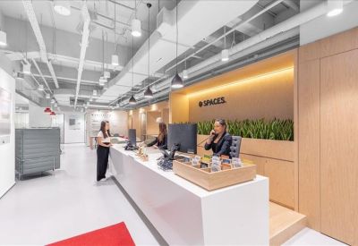 Professional reception area featuring a long white desk and branded signage.