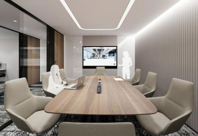 Professional meeting room with a wooden table, sleek beige chairs, and integrated video conferencing technology.