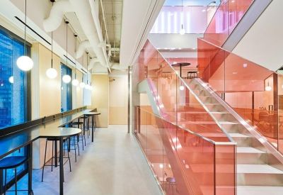 Sleek hallway with a window-side breakfast bar and a modern staircase with pink glass panels.