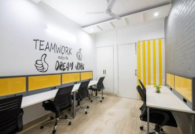 Narrow workspace with inspirational wall art and yellow accents.