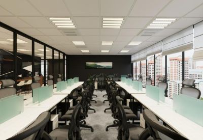Symmetrical open-plan office with two long rows of white workstations and large windows.
