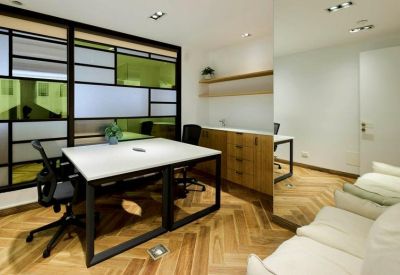 Modern private office suite with a dual-person desk and a mirrored feature wall.