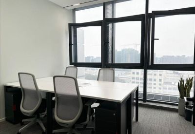 Bright four-person office suite with ergonomic chairs and city views through large windows.