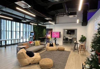 Casual lounge area with bean bags, a rug, and a decorated Christmas tree.