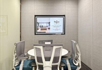 Stylish lounge area with sleek brown seating and large windows overlooking the city.