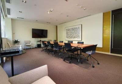 Spacious boardroom at 123 Camberwell Road with a long wood table, modern art, and large windows.