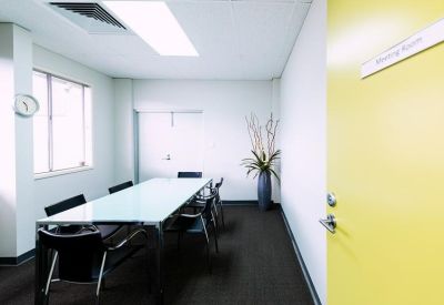 Meeting room with a glass table and black chairs