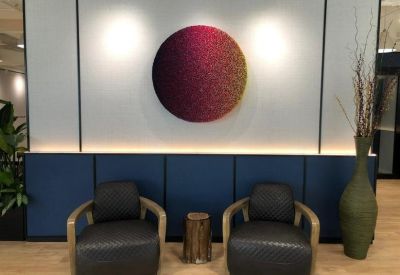Lounge area featuring a circular gradient wall feature and plush armchairs.