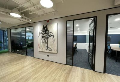 Professional hallway with glass partitions and stylized line art.