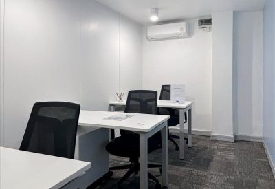 Private office suite with two white desks and ergonomic black chairs.