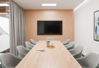A professional boardroom at 14-16 Yarra Street, Level 1 with a wooden feature wall and light timber table.