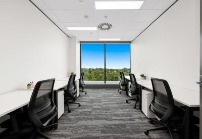 Small office suite with four desks and a window view.