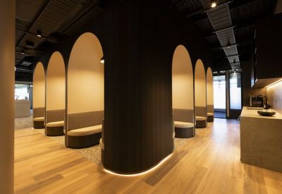 Unique arched seating pods in a dark wood-paneled lounge area.