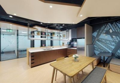 Kitchen and dining area with a long wooden table and modern cabinetry.