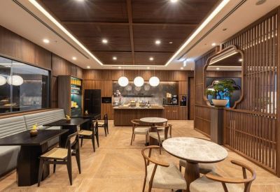 Modern dining area with dark wood tables, marble accents, and a slatted wood partition.