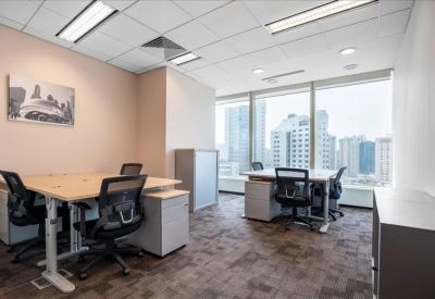 Bright multi-person office suite with large windows and city views.