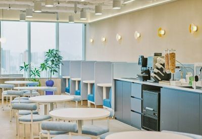Bright breakout area at 15 Yeongjung-ro, Times Square, featuring cafe seating and a blue kitchenette.