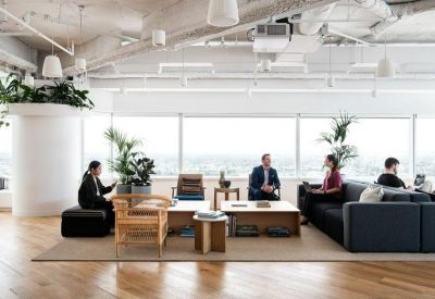 Bright, open-plan lobby and breakout space with large windows and city views.