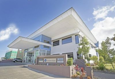 Modern exterior of the building at 155 Varsity Parade with a large white cantilevered roof and glass entrance.