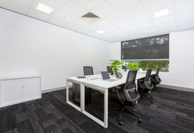 Private three-person office suite with white desks and black chairs.