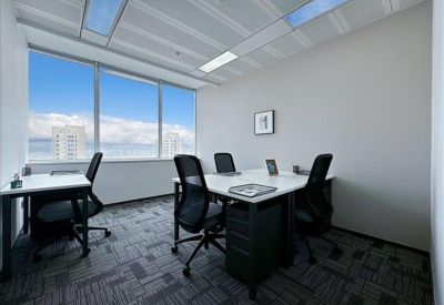 Private office for three people with blue sky views through large windows.