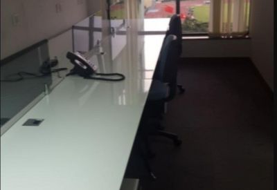 Bright workspace featuring long white desks with panoramic views of the harbor.